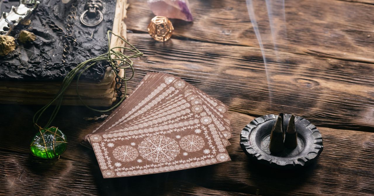 Tarot Cards with Burning Herbal Incense on a Table