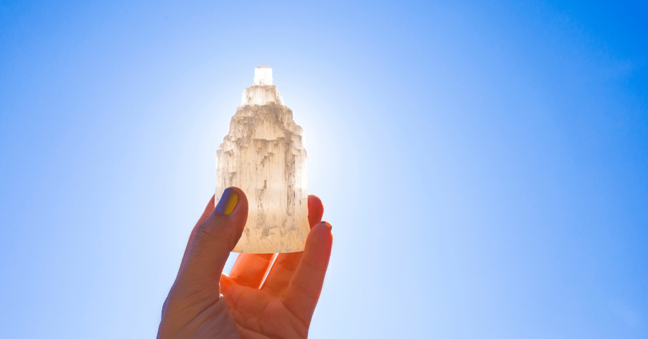 A Person Holding Crystal with a Sunshine Background