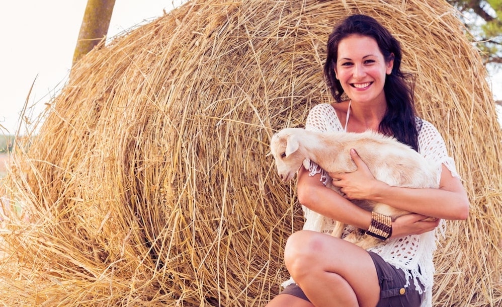 Baby goat in a woman's arms