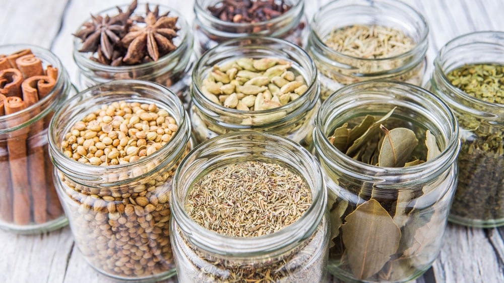 Open mason jars filled with herbs and magick ingredients