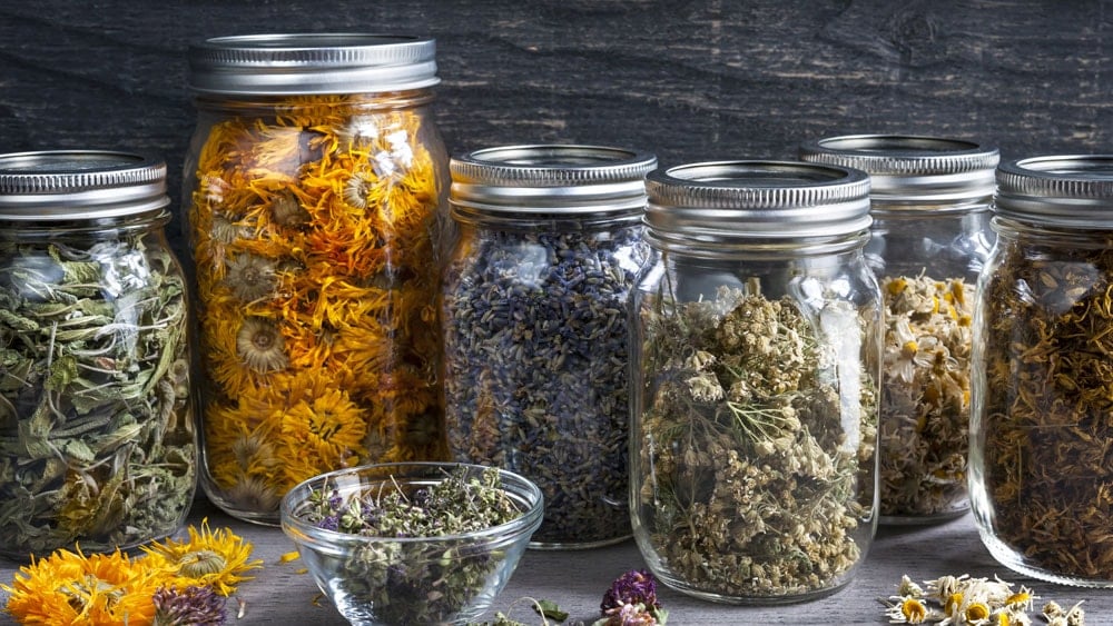 Closed mason jars filled with different spell ingredients