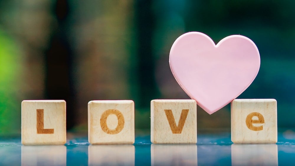 Wooden tiles spelling out love with a heart above