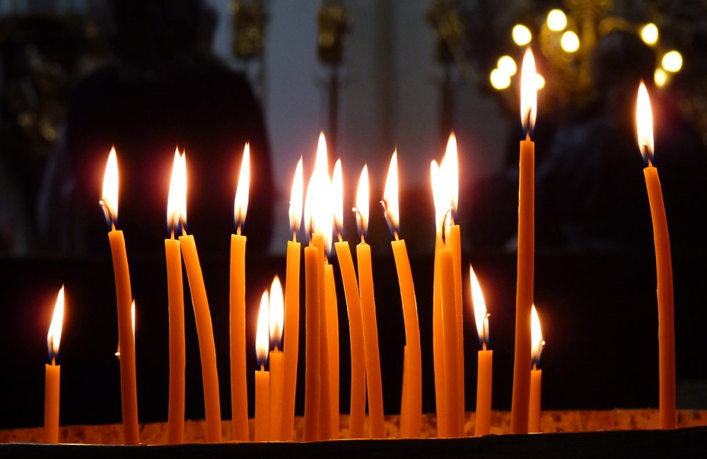 Lit candles in a church in Prague