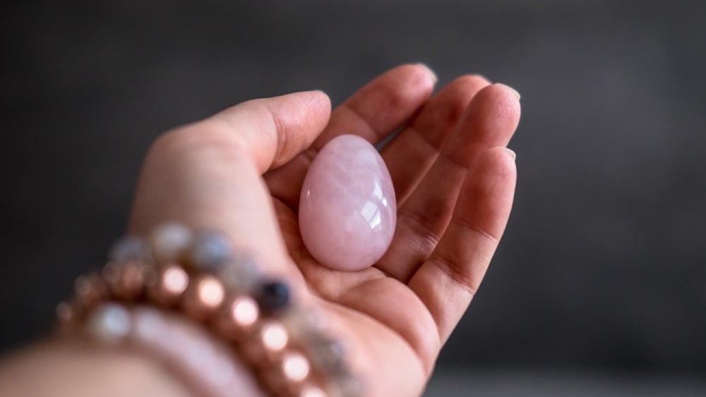 Holding a rose quartz pocket stone in your hand