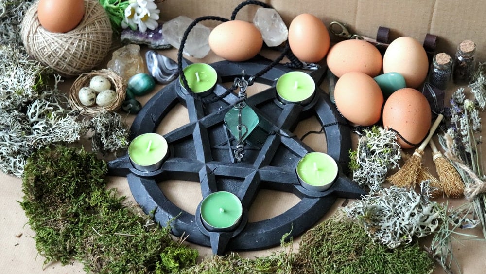 An Ostara altar with candles, eggs, moss, and lavender