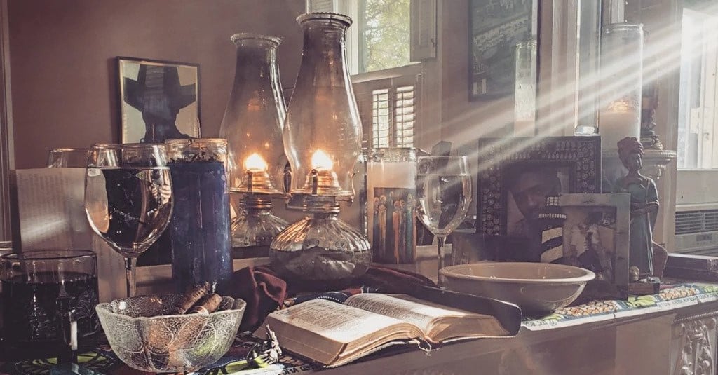 a hoodoo ancestor altar featuring images and mementos of loved ones