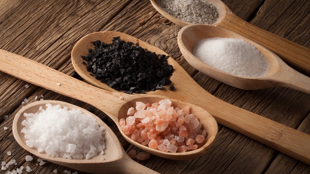 Spoonfuls of different varieties of salt