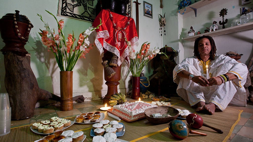 Baptized in Santeria a man is reborn with a different name and for the first year has to wear white. Here, the birthday party of Lazaro Salsita, born 15 years ago in the body of Lazaro Medina Hernandez, 35, Sculptor. Havana (La Habana), Cuba