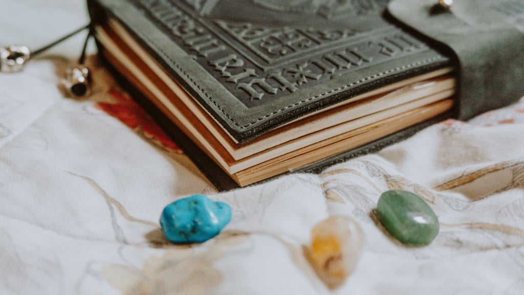 A book of shadows with crystals sitting in front
