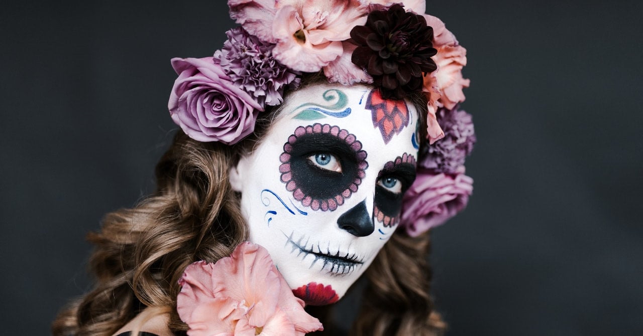 A woman dressed for Dia de Los Muertos