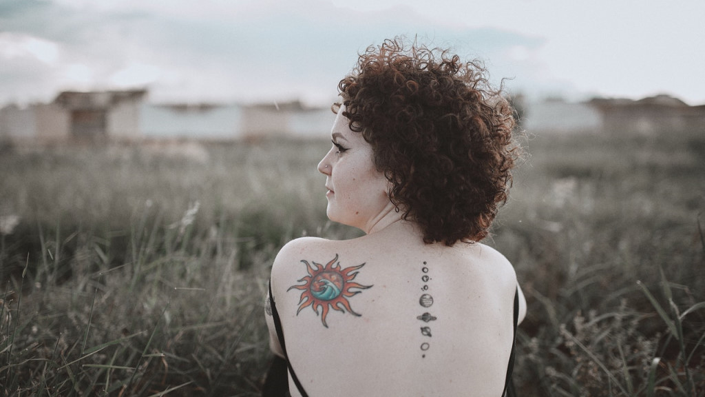 A woman with planetary tattoos on her back