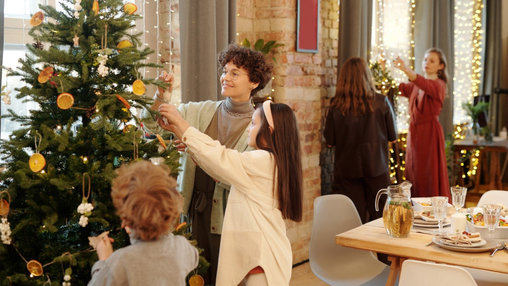 A family decorating a Yule tree with ornaments before a feast