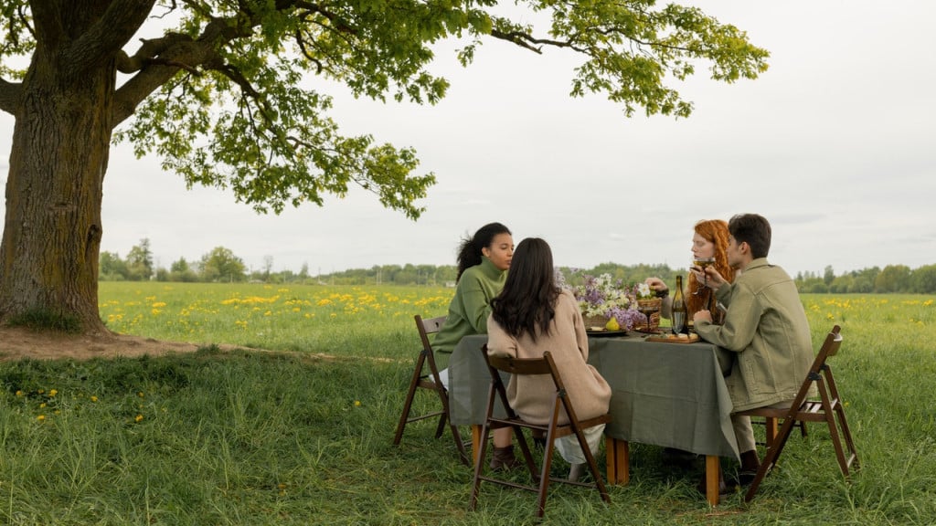 Four friends having a feast outside in the springtime