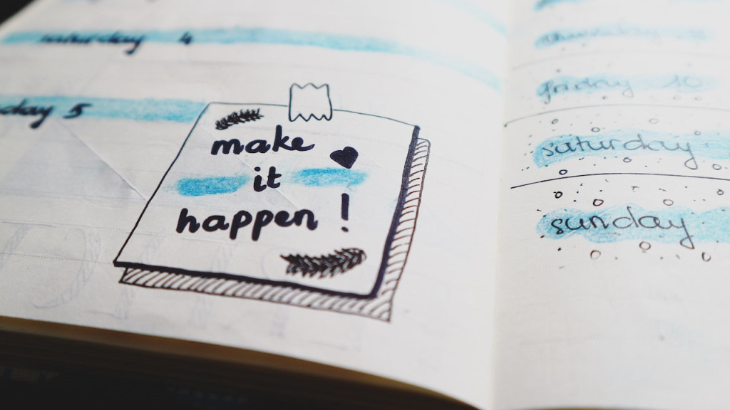 Notebook with the words "make it happen!" written in it