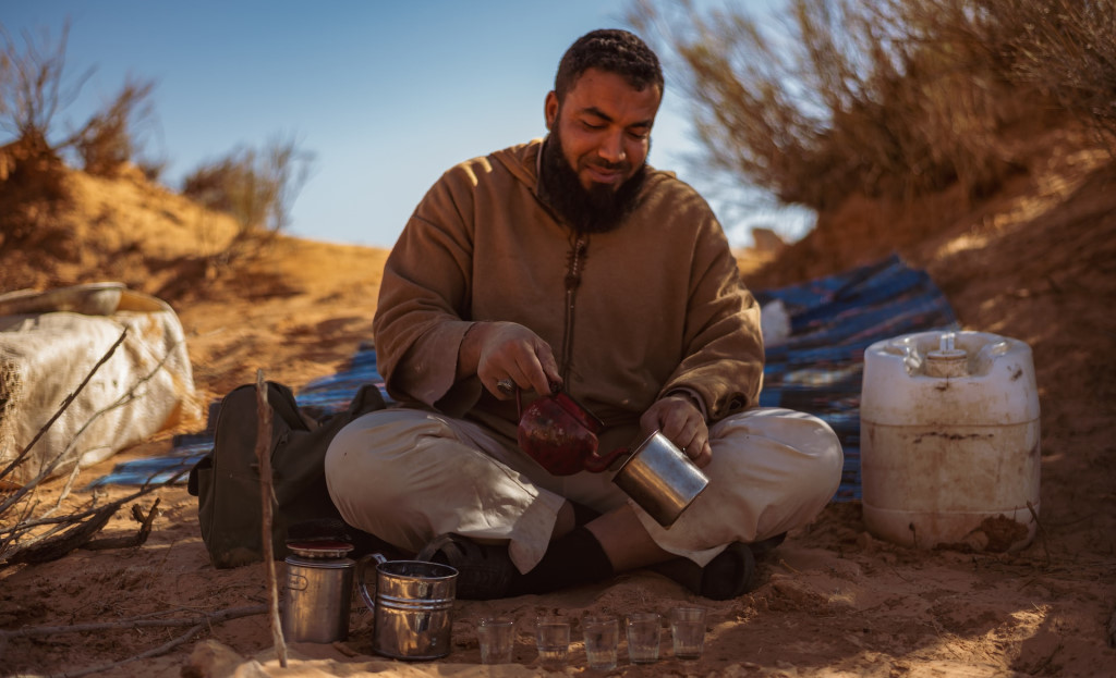 A man making tea in the desert