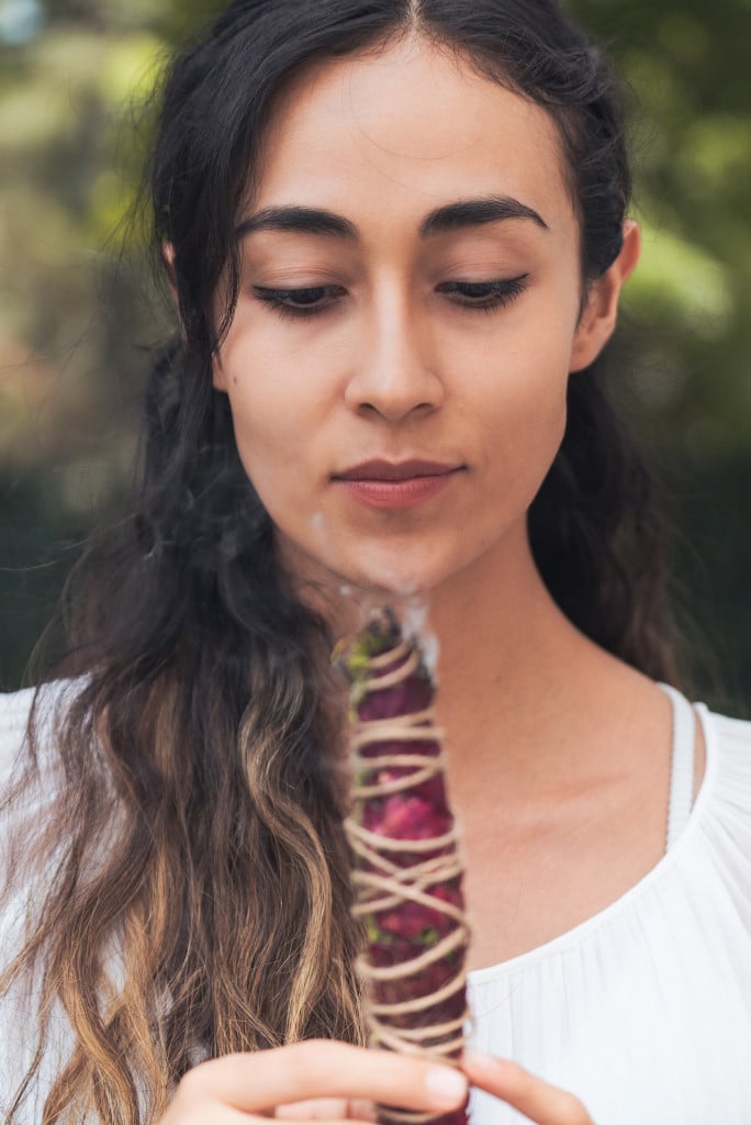 A woman smudging with roses