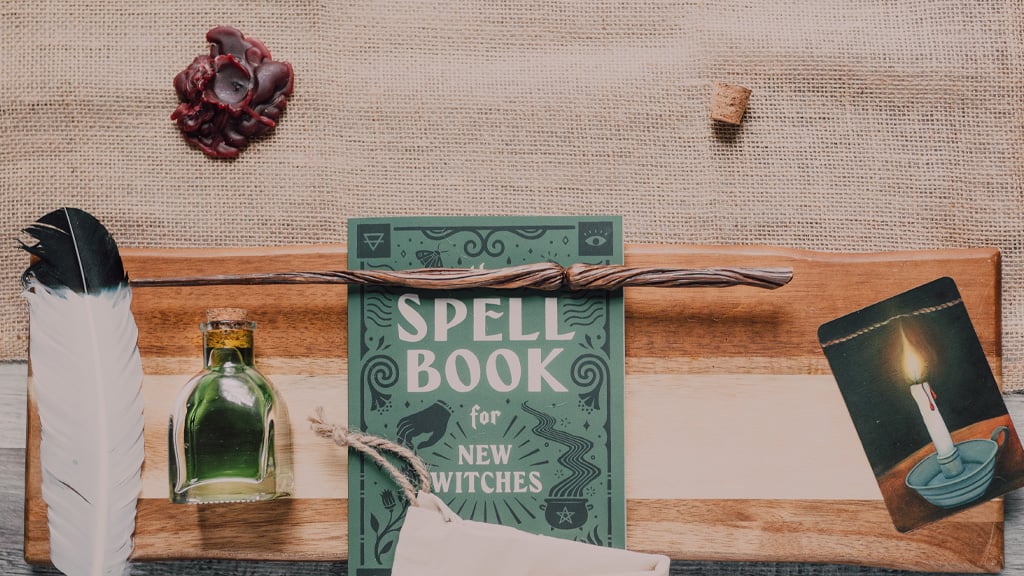 A Spell Book beside a Potion on a table