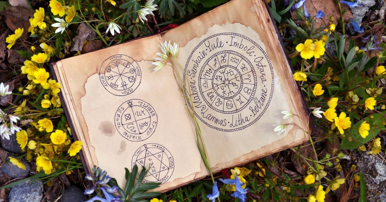 An old book with sigils on the grass