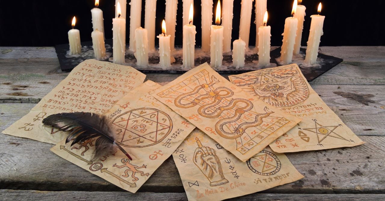 An old papers with sigils and candles on the table