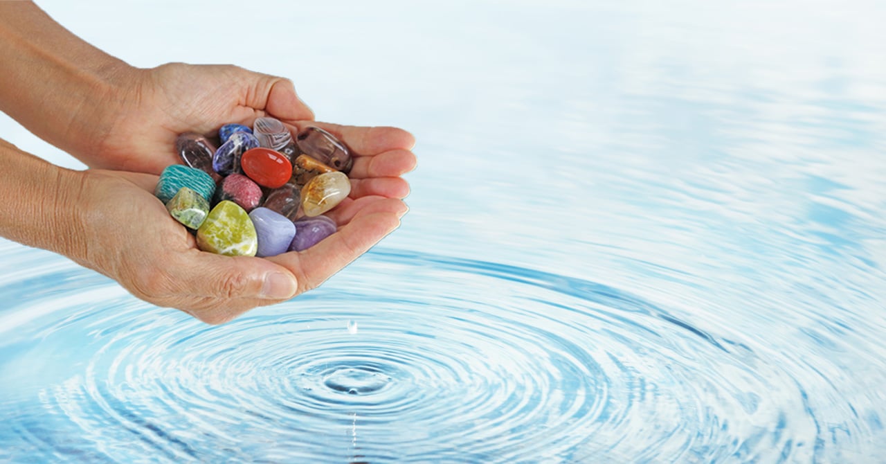 A Person Holding Crystals Before Clean it in the Water