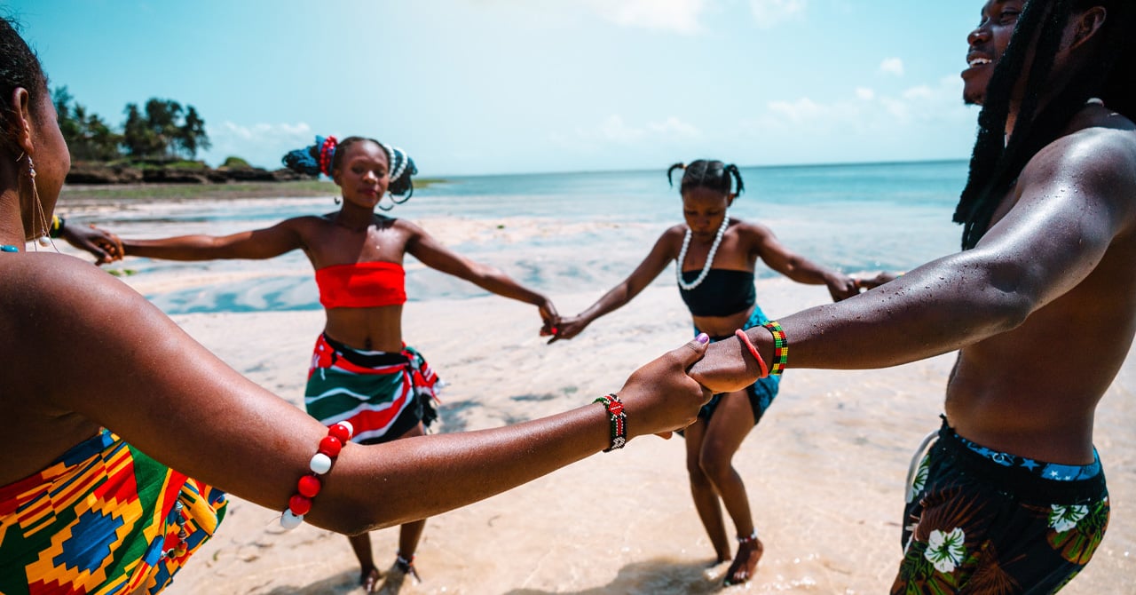 People holding hands dancing on the beach